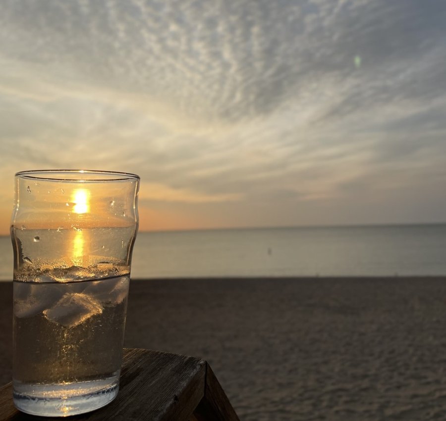 Glass half full, sunrise reflected on the water